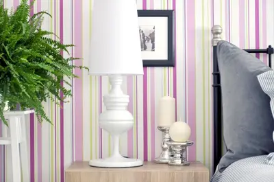 a white lamp on a table next to a bed at Chic & Cheap in Barcelona