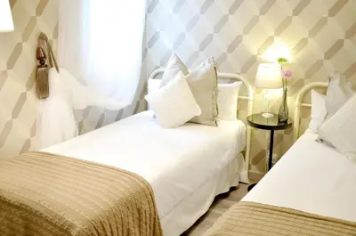 a hotel room with two beds and a window at Chic & Cheap in Barcelona