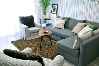 a living room with a couch and two chairs at Chic & Cheap in Barcelona
