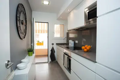 a kitchen with a sink and a counter with oranges on it at Charming & Quiet Park Guell Apartment in Barcelona
