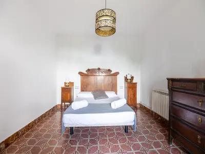 a bedroom with a bed and a dresser at Can Teulera in San Martín Sarroca