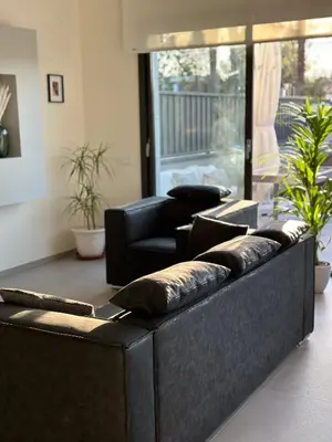 a living room with leather couches in a room at Shome in Vilanova i la Geltrú