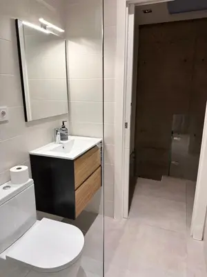 a bathroom with a toilet and a sink and a mirror at Shome in Vilanova i la Geltrú