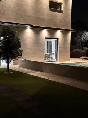 a building with a swimming pool at night at Shome in Vilanova i la Geltrú
