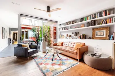 a living room with a couch and a table at ArtlifeBCN Fira Apartment in Barcelona