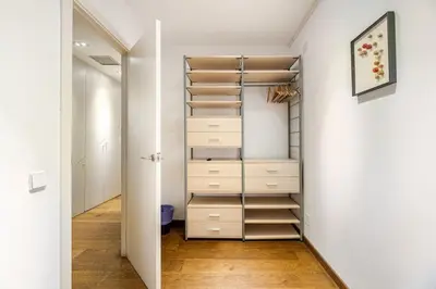 a walk in closet with drawers and shelves at ArtlifeBCN Fira Apartment in Barcelona