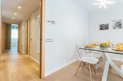 a kitchen and dining room with a table and chairs at Top family apartment by Lofties in Terrassa