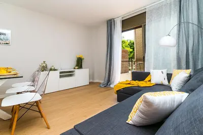 a living room with a blue couch and a window at Top family apartment by Lofties in Terrassa