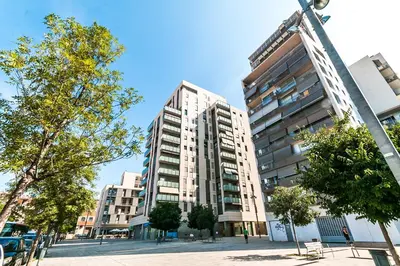 a tall apartment building in a city with trees at Top family apartment by Lofties in Terrassa