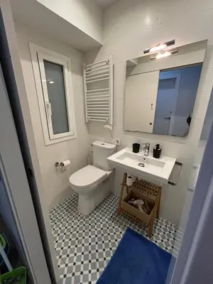 a walk in closet with white shelves and a mirror at Palau Rooms in Barcelona