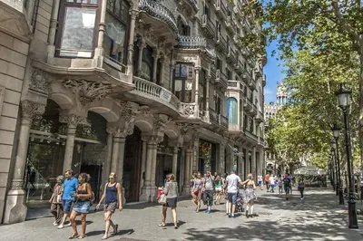 a group of people walking in front of a building at Habitat Apartments Barcelona Plaza in Barcelona