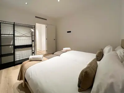 two beds in a room with a balcony at Stay U-nique Apartments Putxet in Barcelona