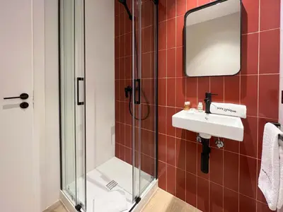 a bathroom with a shower and a sink and a mirror at Stay U-nique Apartments Putxet in Barcelona