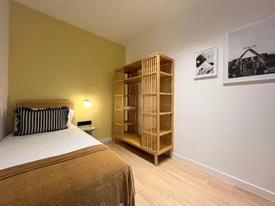 a bedroom with a bed and a book shelf at Stay U-nique Apartments Putxet in Barcelona