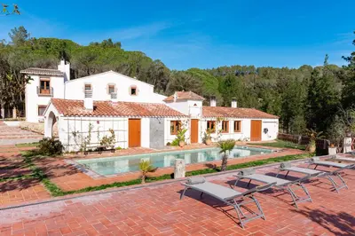 a villa with a swimming pool and a house at La Terraza - Großzügiges Appartment in Katalanischer Masia in Sant Iscle de Vallalta