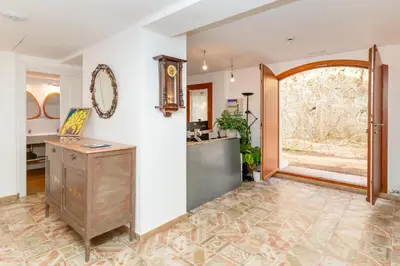 an empty room with a table and a mirror on the wall at La Terraza - Großzügiges Appartment in Katalanischer Masia in Sant Iscle de Vallalta