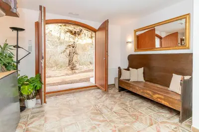 a living room with a bench and a window at La Terraza - Großzügiges Appartment in Katalanischer Masia in Sant Iscle de Vallalta