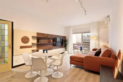 a living room with a couch and a table and chairs at Maria Poblenou Apartment by Olala Homes in Barcelona