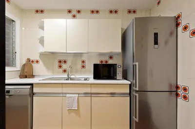 a kitchen with a stainless steel refrigerator and a sink at Maria Poblenou Apartment by Olala Homes in Barcelona