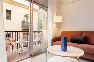 a living room with a couch and a table at Maria Poblenou Apartment by Olala Homes in Barcelona