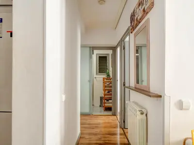 a hallway with white walls and wood floors at Espalter White by Hello Homes Sitges in Sitges