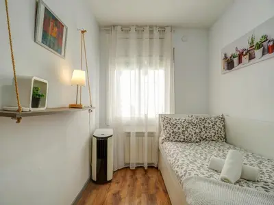 a small room with a bed and a window at Espalter White by Hello Homes Sitges in Sitges