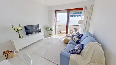 a living room with a blue couch and a tv at Premium Habitat Del Far in Arenys de Mar