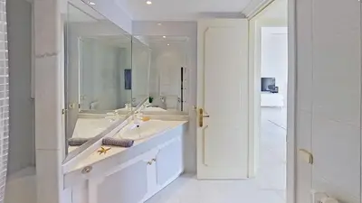 a white bathroom with a sink and a mirror at Premium Habitat Del Far in Arenys de Mar