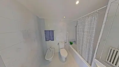 a white bathroom with a toilet and a shower at Premium Habitat Del Far in Arenys de Mar