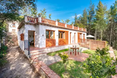 a house with a garden and a patio at Ginkgo - Familienfreundliches Appartment in Katalanischer Masia in Sant Iscle de Vallalta