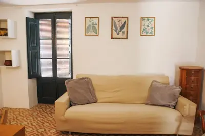 a living room with a couch in front of a door at Cal Teixidor in Mediona