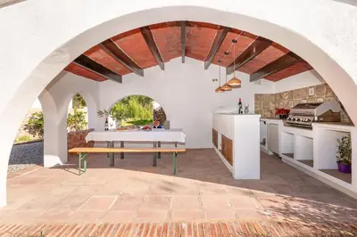 a kitchen with an arched ceiling with a table and a bench at Gallinero - Familienfreundliches Appartment in Katalanischer Masia in Sant Iscle de Vallalta