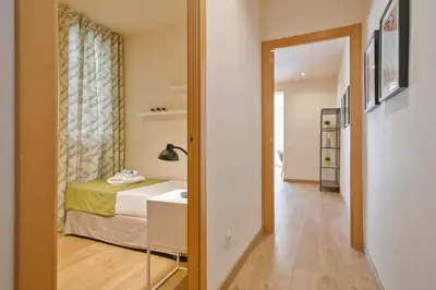 a small bedroom with a bed and a mirror at Alcam Galileu P in Barcelona