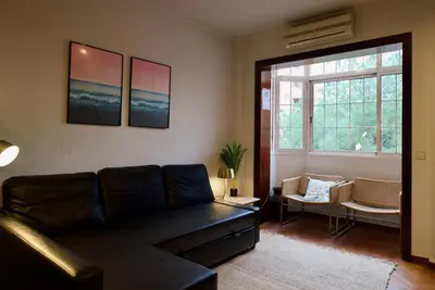 a living room with a couch and a window at Corcega - Sagrada Familia in Barcelona