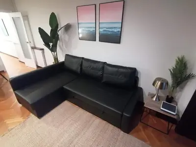 a black leather couch in a living room at Corcega - Sagrada Familia in Barcelona
