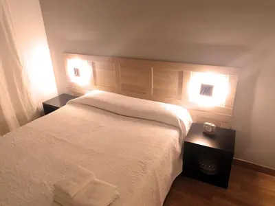 a bedroom with a white bed with two night stands at Corcega - Sagrada Familia in Barcelona