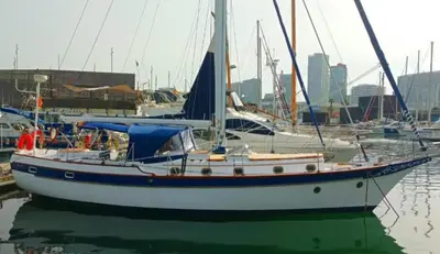 a sailboat is docked in a harbor with other boats at Vintage and cozy sailing boat in Barcelona in Barcelona