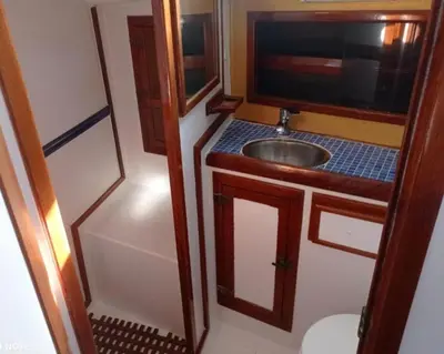 a small bathroom with a sink and a mirror at Vintage and cozy sailing boat in Barcelona in Barcelona