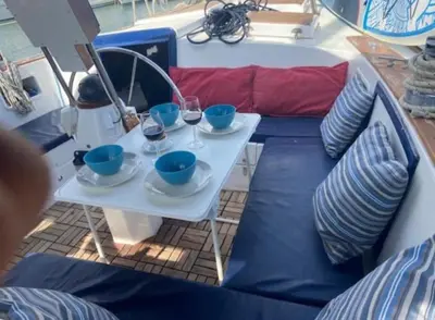 a table on a boat with glasses of wine at Vintage and cozy sailing boat in Barcelona in Barcelona