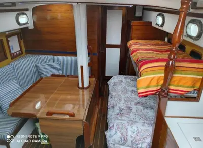 a bedroom with a bed and a desk in a boat at Vintage and cozy sailing boat in Barcelona in Barcelona