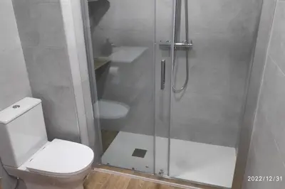 a bathroom with a shower with a toilet and a sink at Precioso apartamento con magnífico patio. in Sant Feliu de Llobregat