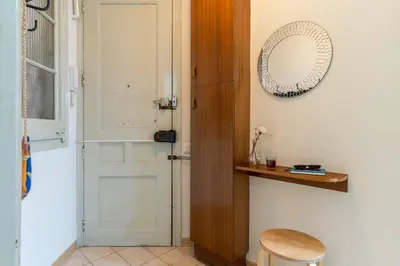 a room with a door and a mirror and a stool at Canela Homes BARCELONA LESSEPS in Barcelona