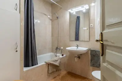 a bathroom with a sink and a tub and a toilet at Canela Homes BARCELONA LESSEPS in Barcelona