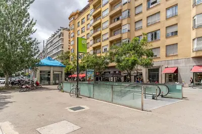 a building with a bike parked in front of a building at Canela Homes BARCELONA LESSEPS in Barcelona