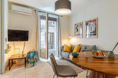 a living room with a couch and a table at Canela Homes BARCELONA LESSEPS in Barcelona