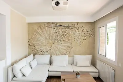 a living room with a white couch and a table at Design Apartment with Sea View in Castelldefels