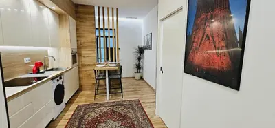a kitchen with a counter and a stool in a room at Gran apartamento ideal grupos muy cerca Barcelona in Badalona