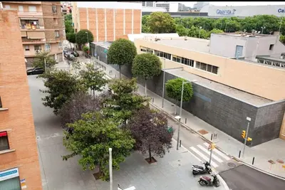 an overhead view of a street with trees and a building at Centric Apartment Gran Via 5 in Hospitalet de Llobregat