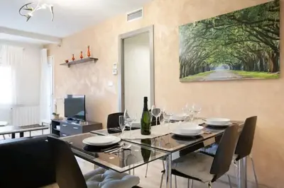 a dining room with a glass table and chairs at Centric Apartment Gran Via 5 in Hospitalet de Llobregat