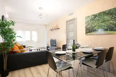 a dining room with a table and a couch at Centric Apartment Gran Via 5 in Hospitalet de Llobregat